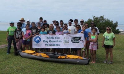 Volunteers holding up a Thank you Bay Guardians Volunteers sign